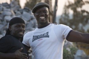 Associate producer and supporting actor Carlos Ombonya with supporting actor Leon Menya on set.